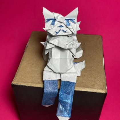 A feline-looking humanoid, resembling meme character "silly cat" by mauzymice, sitting on a box